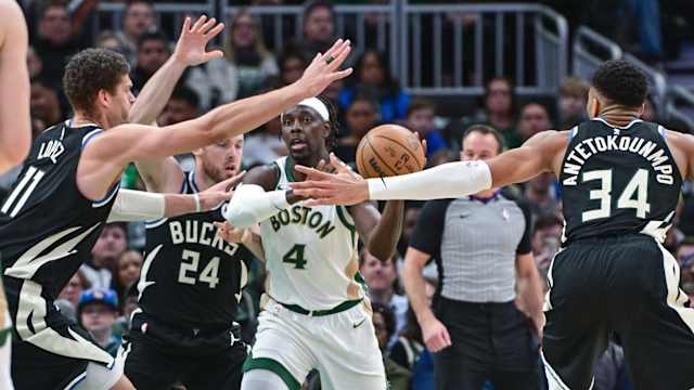 Boston Celtics guard Jrue Holiday (4) gets pressure from Milwaukee Bucks center Brook Lopez (11), guard Pat Connaughton (24) and forward Giannis Antetokounmpo (34) 